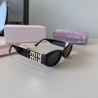 Miu Miu Black Oval Sunglasses with Gold Accent view 3